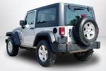 2011 Jeep Wrangler Sport — Bright Silver Metallic exterior view 4, for sale at Lakeside Automotive Group in Spring Lake, MI
