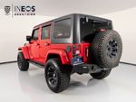 2015 Jeep Wrangler Unlimited Freedom Edition — Red exterior view 3, for sale at RDS Ineos Grenadier in Devon, PA