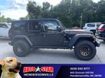 2024 Jeep Wrangler Rubicon — Black Clearcoat exterior view 3, for sale at Autostar CDJR of Hendersonville in Hendersonville, NC