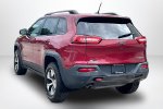 2015 Jeep Cherokee Trailhawk — Deep Cherry Red Crystal Pearlcoat exterior view 4, for sale at Lakeside Automotive Group in Spring Lake, MI