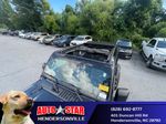 2024 Jeep Wrangler Rubicon — Black Clearcoat exterior view 2, for sale at Autostar CDJR of Hendersonville in Hendersonville, NC
