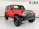 2015 Jeep Wrangler Unlimited Freedom Edition — Red exterior view 7, for sale at RDS Ineos Grenadier in Devon, PA