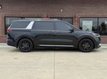 2024 Kia Carnival SX — Aurora Black exterior view 4, for sale at Velocity Auto Source in RICHMOND, KY