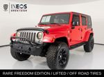 2015 Jeep Wrangler Unlimited Freedom Edition — Red primary exterior view, for sale at RDS Ineos Grenadier in Devon, PA